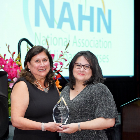 Angie Millan (left) presents NAHN's Nurse of the Year Award to Michele Crespo-Fierro